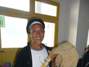 A farmer from Nandan County of Guangxi Province shows a kind of traditional sticky rice