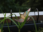 A little bird created by the children flies up in the air