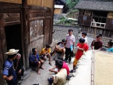 Miao youngsters, with paper and pens in their hands, interview their elders about the Miao's migration history.
